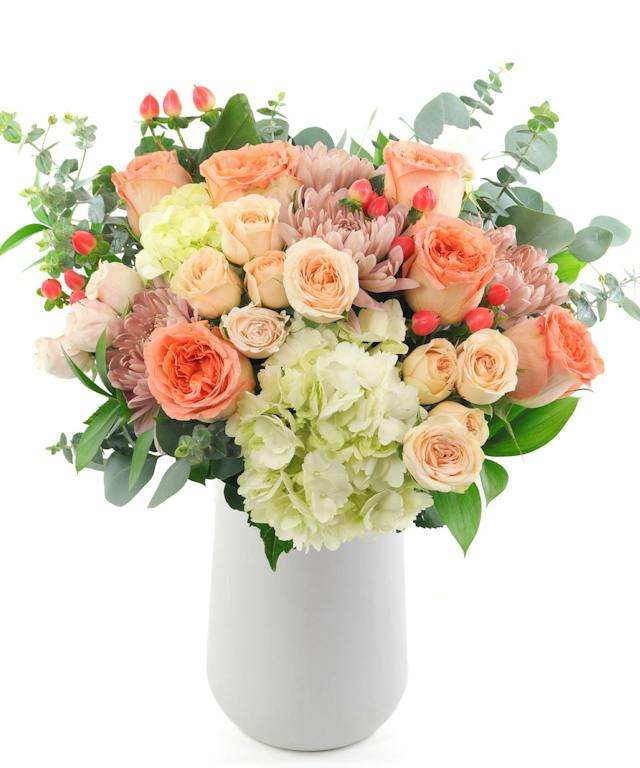 Feeling Peachy from Allen’s Flowers, with peach roses, white hydrangeas and eucalyptus.